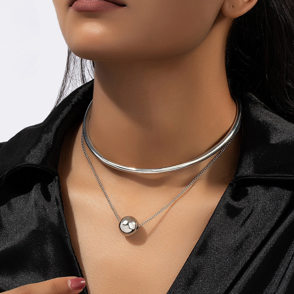 A niche design combination of stacked round ball necklaces and collars
